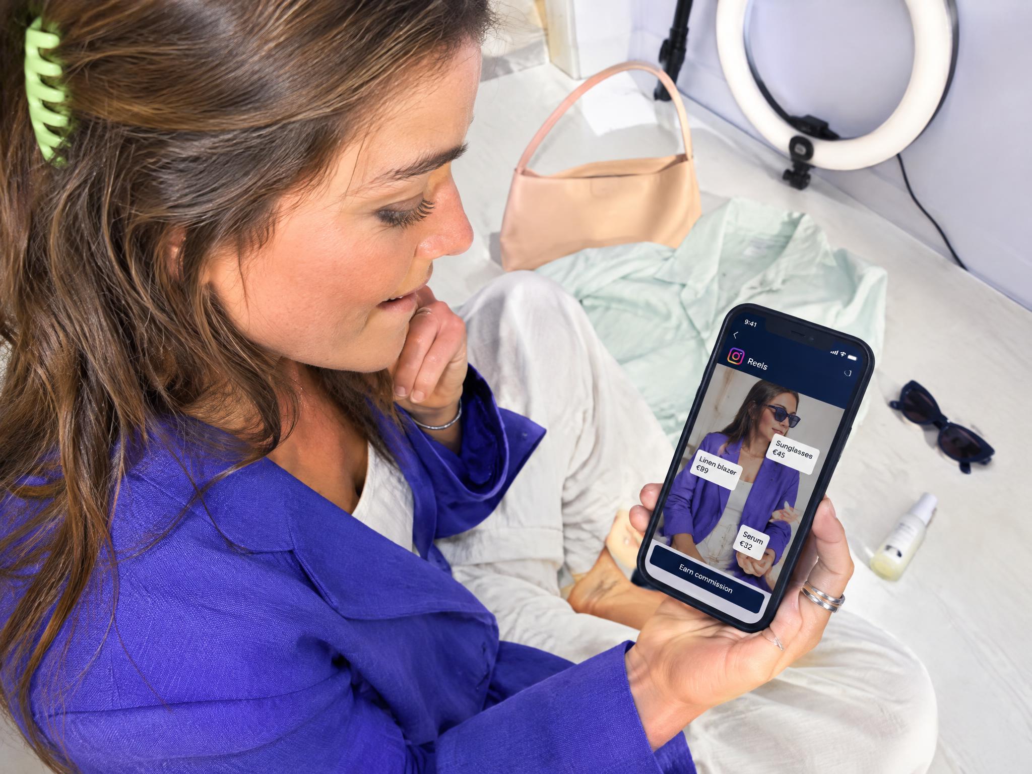 Woman viewing an Instagram Reel with tagged products on her smartphone
