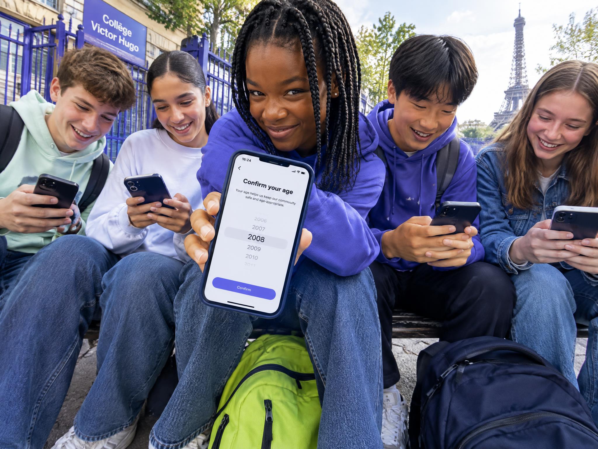 French teenagers on their phones near the Eiffel Tower, one showing an age confirmation screen